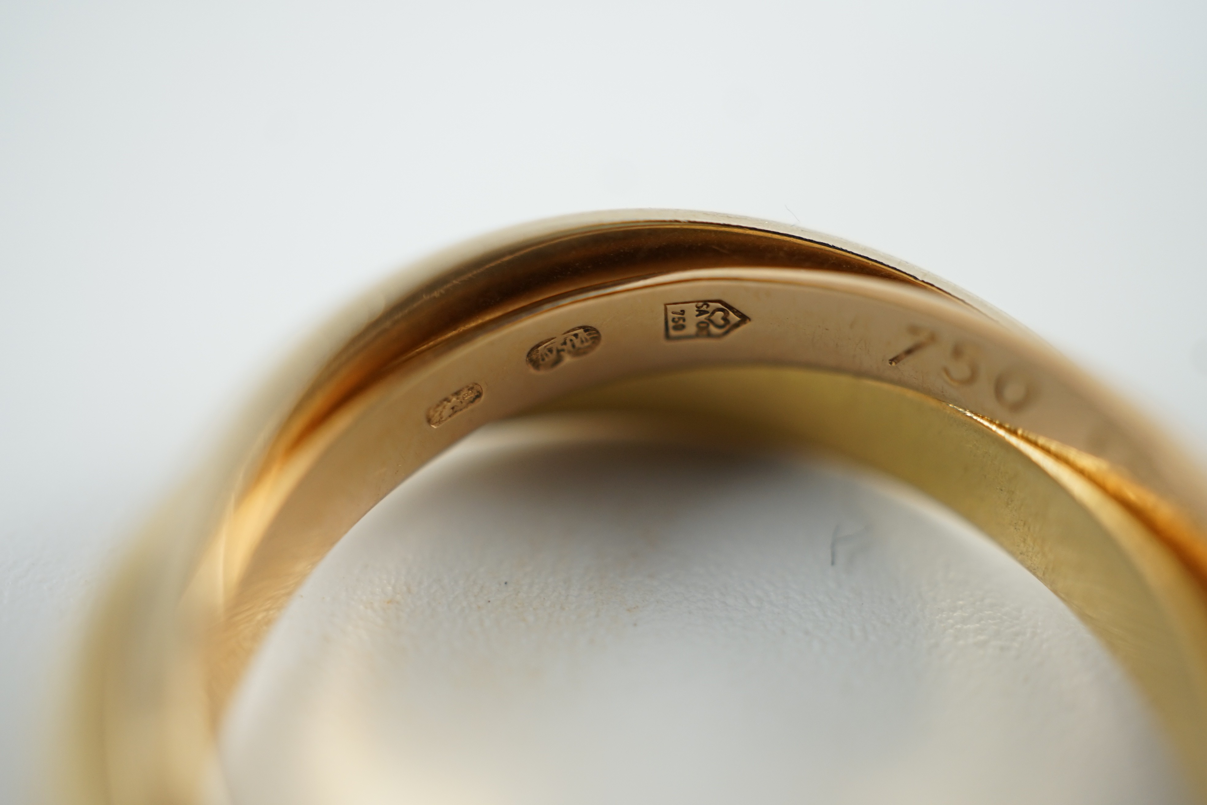 A modern 18ct three colour Cartier 'Russian' triple wedding band